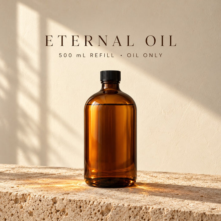 Azhara Eternal Oil 500 mL refill: amber glass bottle of clean-burning lamp oil on travertine. Oil only.
