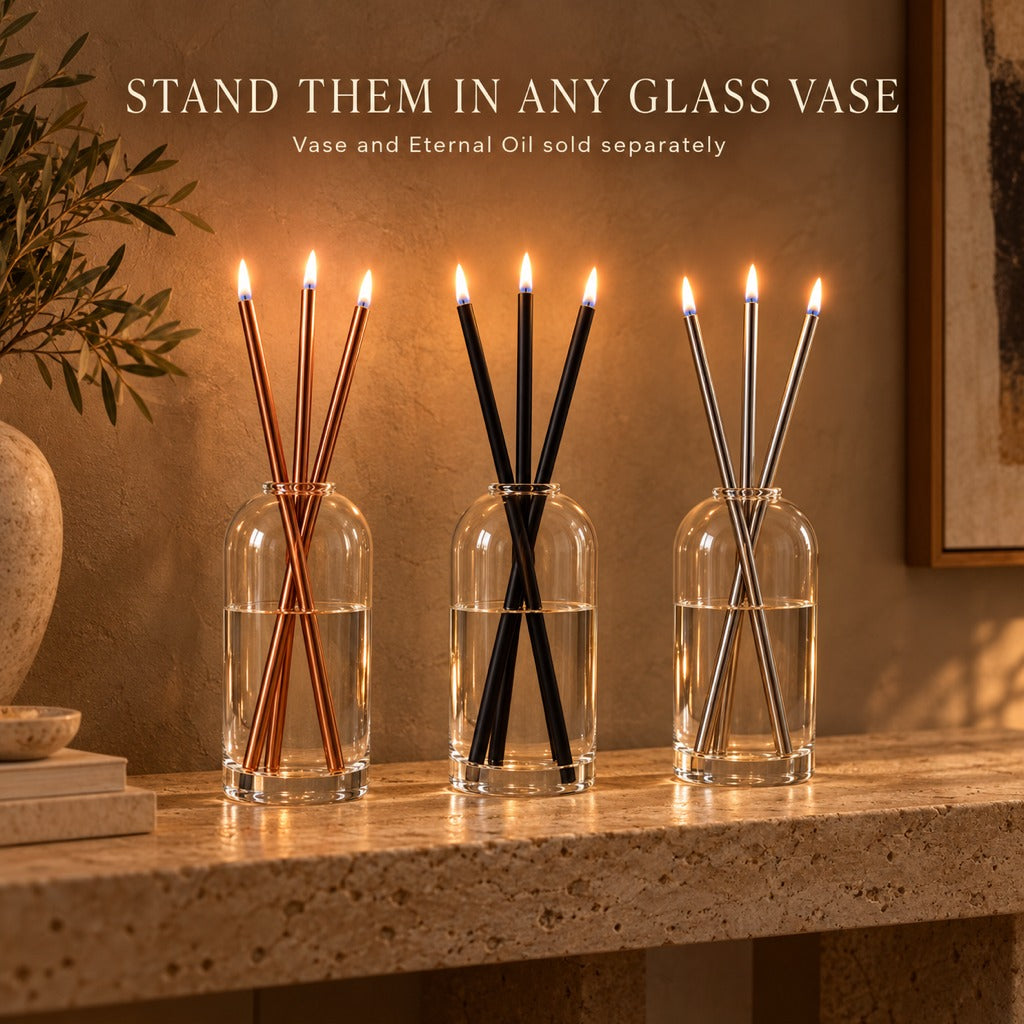 Rose gold, black and silver Eternal Candles lit in glass vases. Vase and oil sold separately.