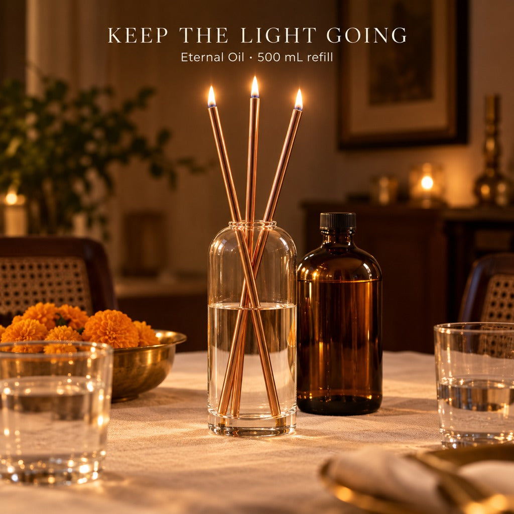 Lit rose gold Eternal Candles on a dining table beside the 500 mL Eternal Oil bottle