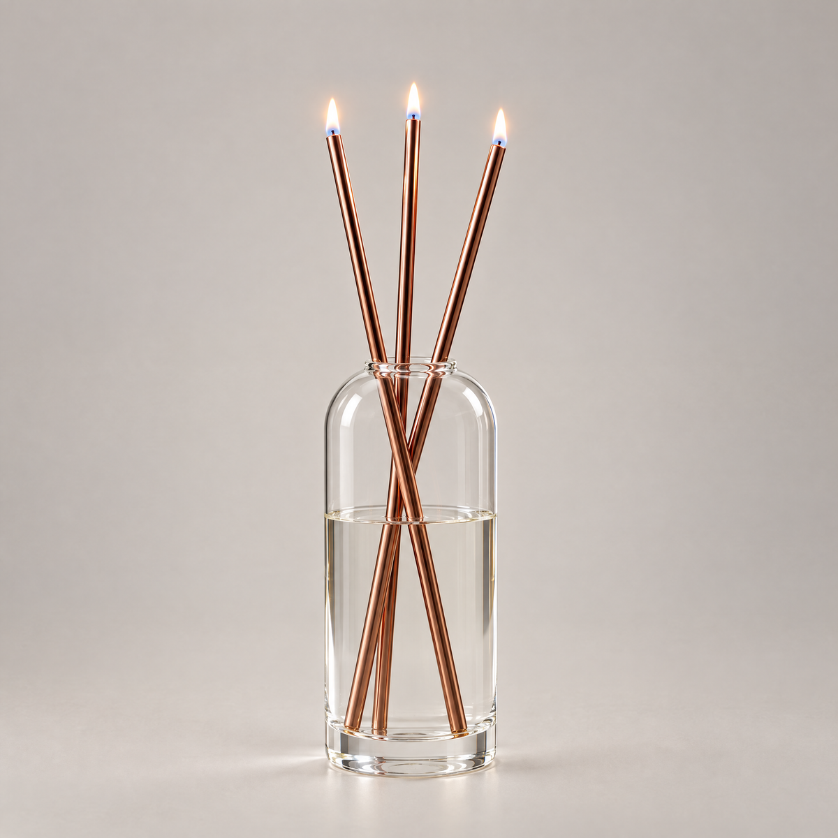 Azhara Eternal Candle Set in rose gold - three lit refillable oil candles in a clear glass vase